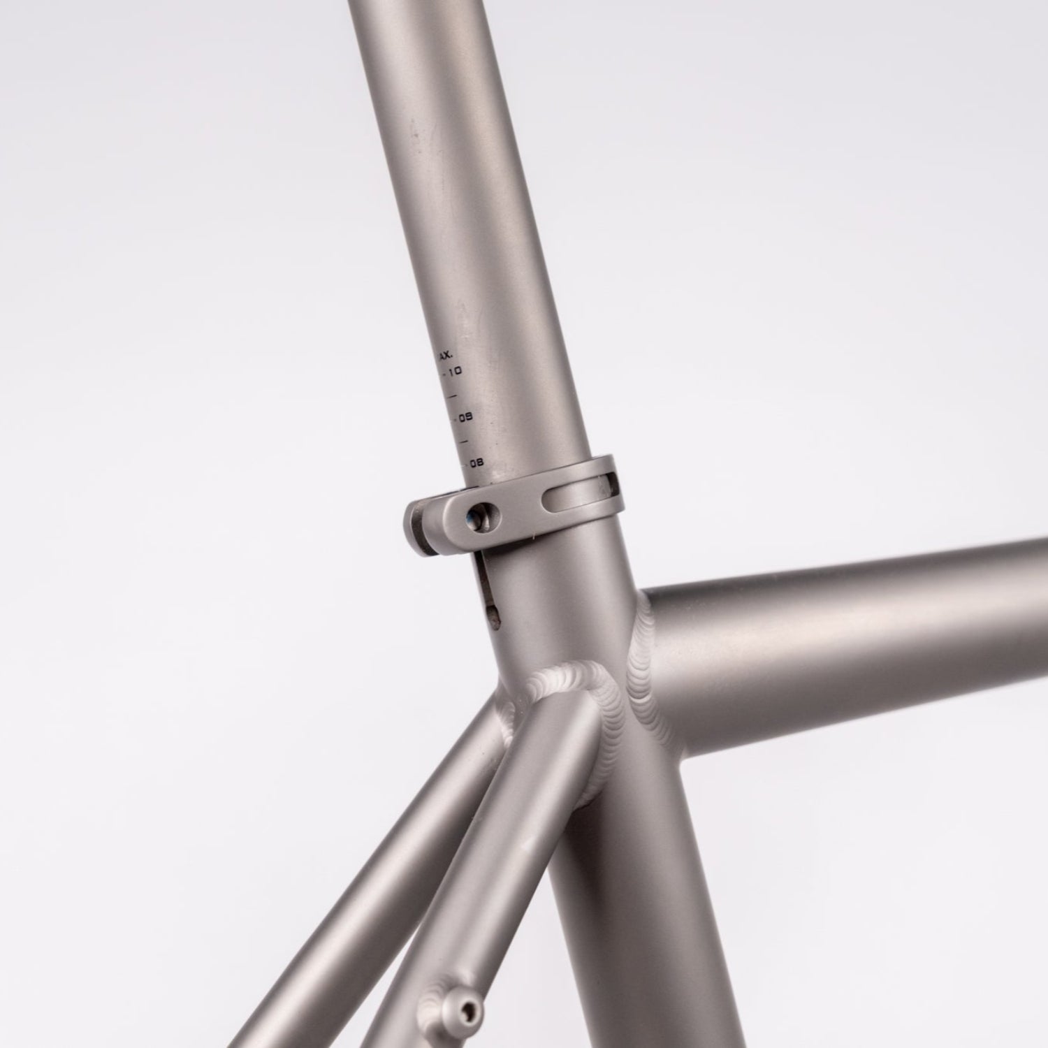 Close-up of a metallic bike frame on a light gray background