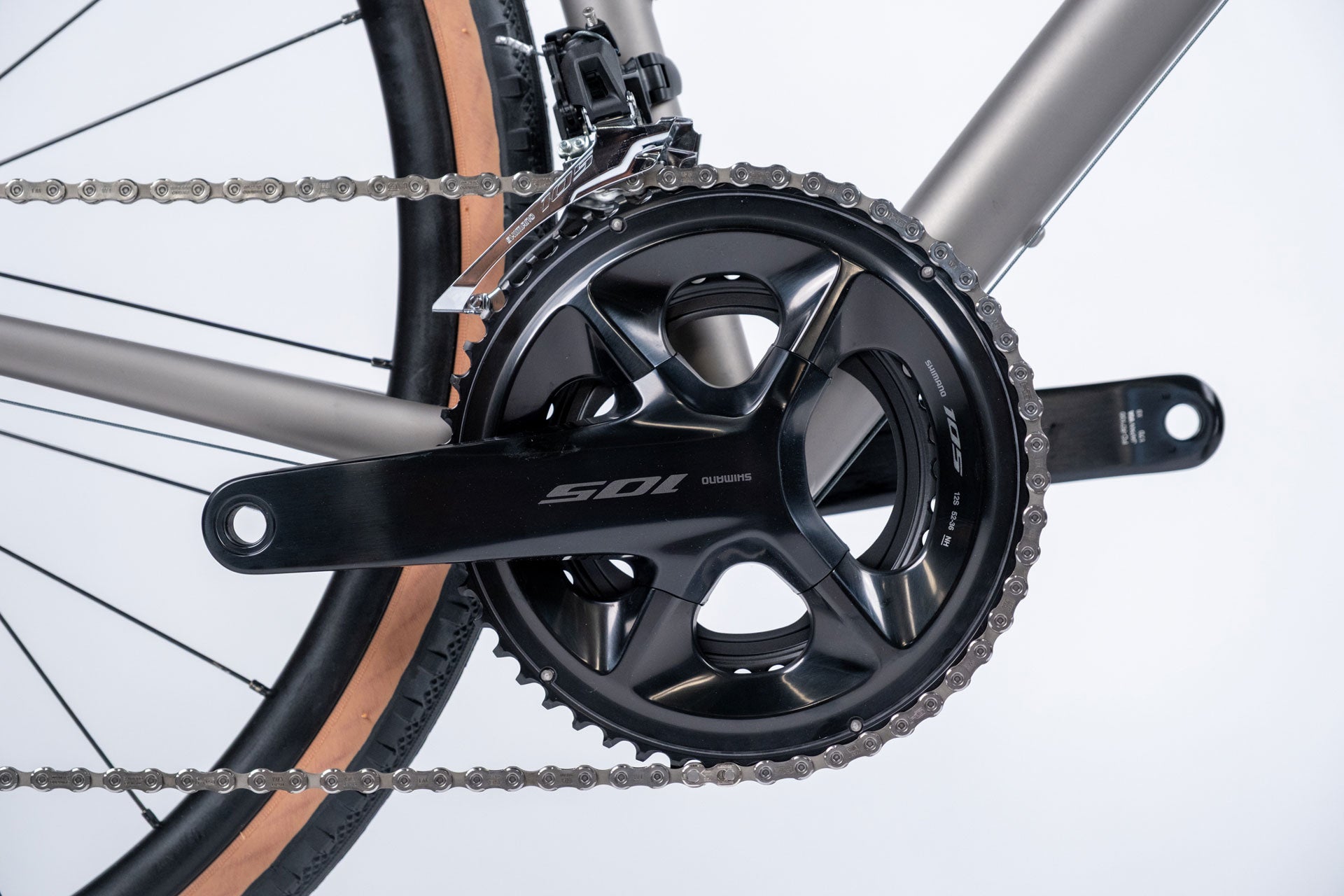 Close-up of a bicycle chainring and chain on a white background