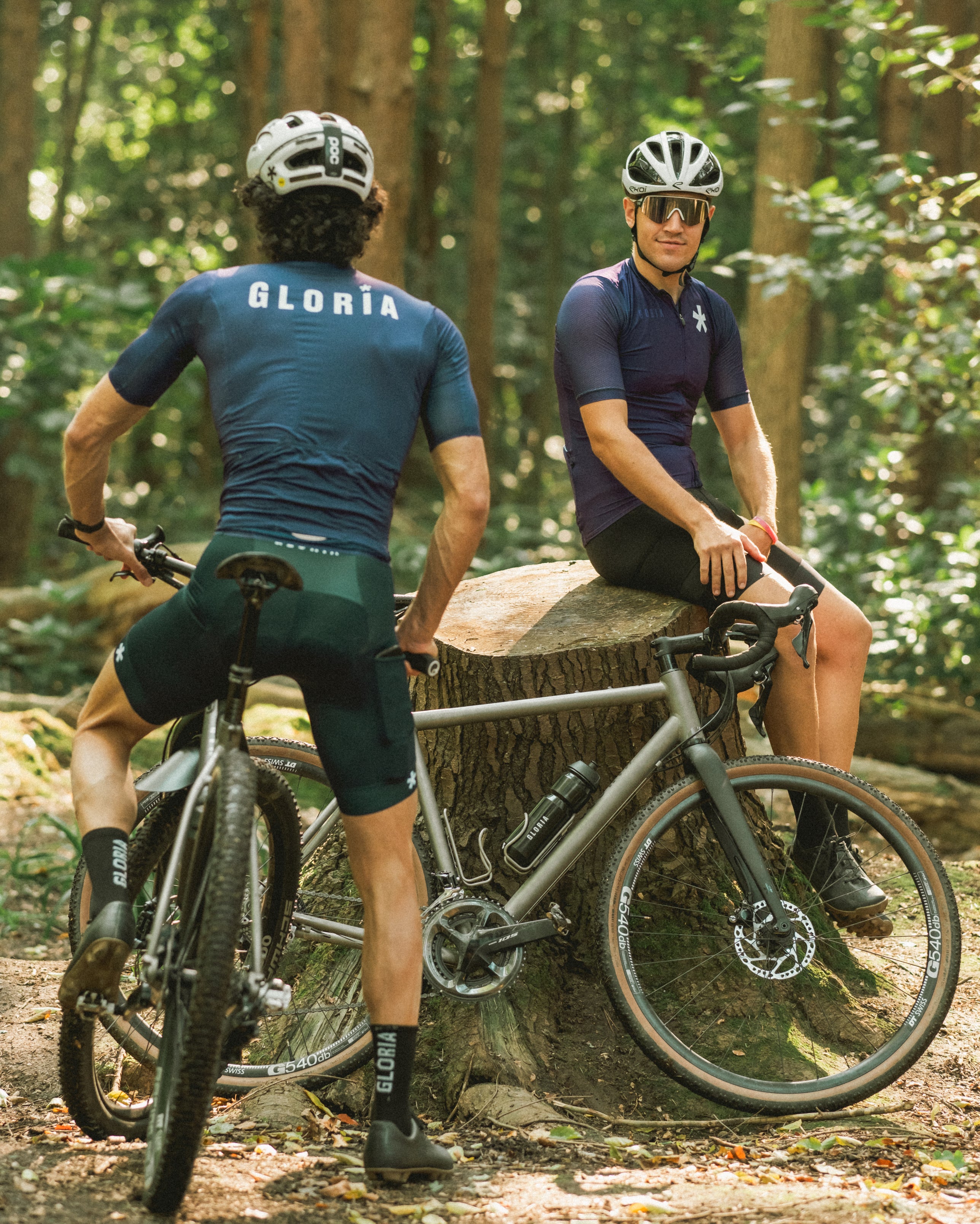two people in a forest on an All-Road and All-Terrian