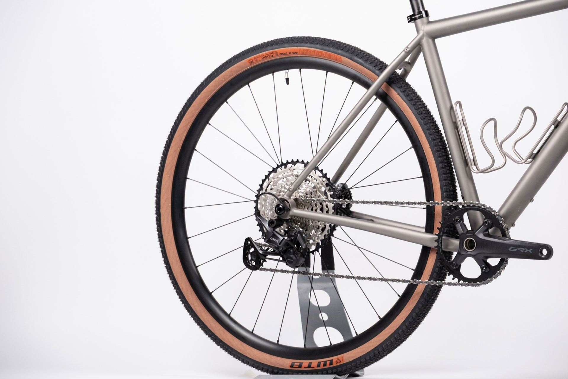 A silver and black gravel bike wheel with Shimano GRX 610 groupset 