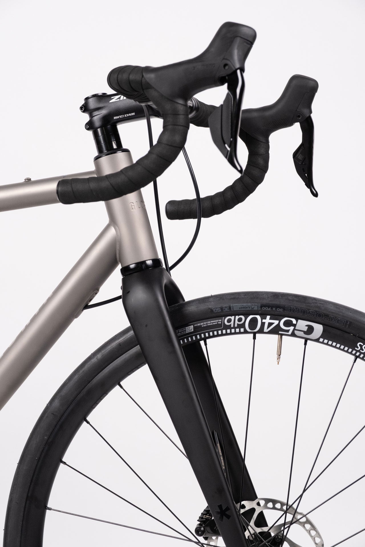 A titanium all-road bicycle with Shimano 105 Di2 groupset and DT Swiss Alloy Wheelset, equipped with Zipp Service Course handlebars and a Selle Italia X1 saddle.