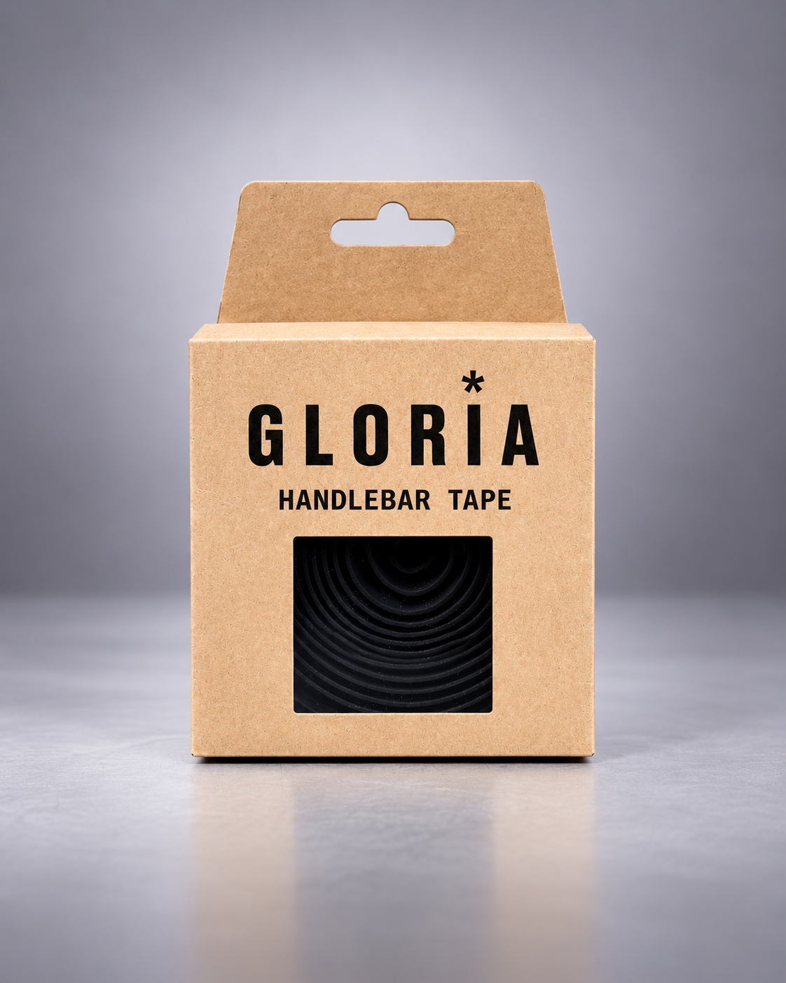 A kraft paper retail box for GLORIA Handlebar Tape, featuring a black window that displays the coiled black tape inside, set against a clean gray studio background.