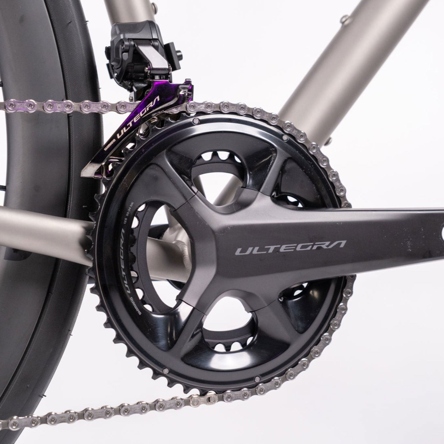 Close-up of a bicycle chain and gear system with 'Ultegra' branding on a white background