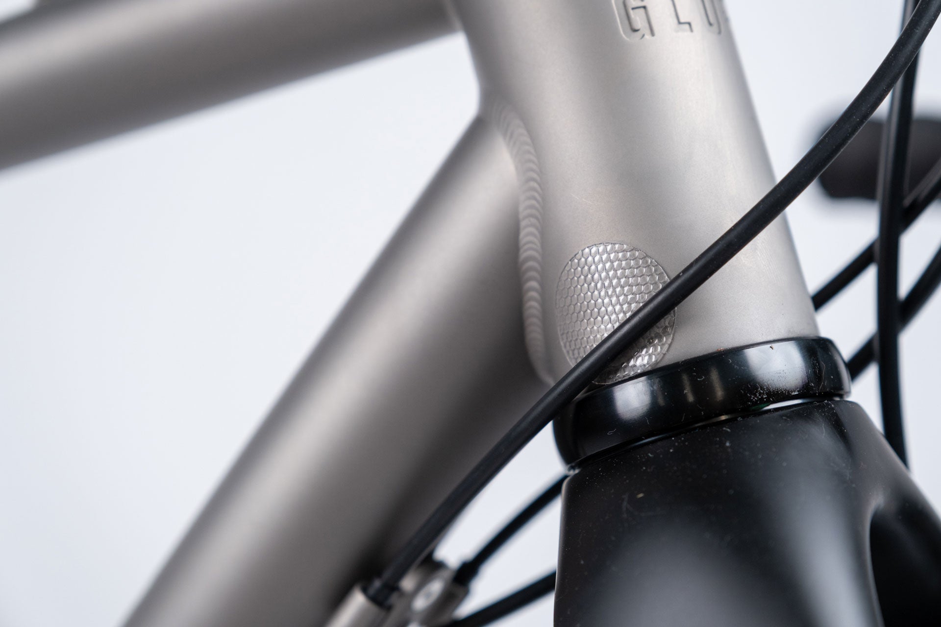 Close-up of a bicycle frame with 'Gloria' branding on a white background