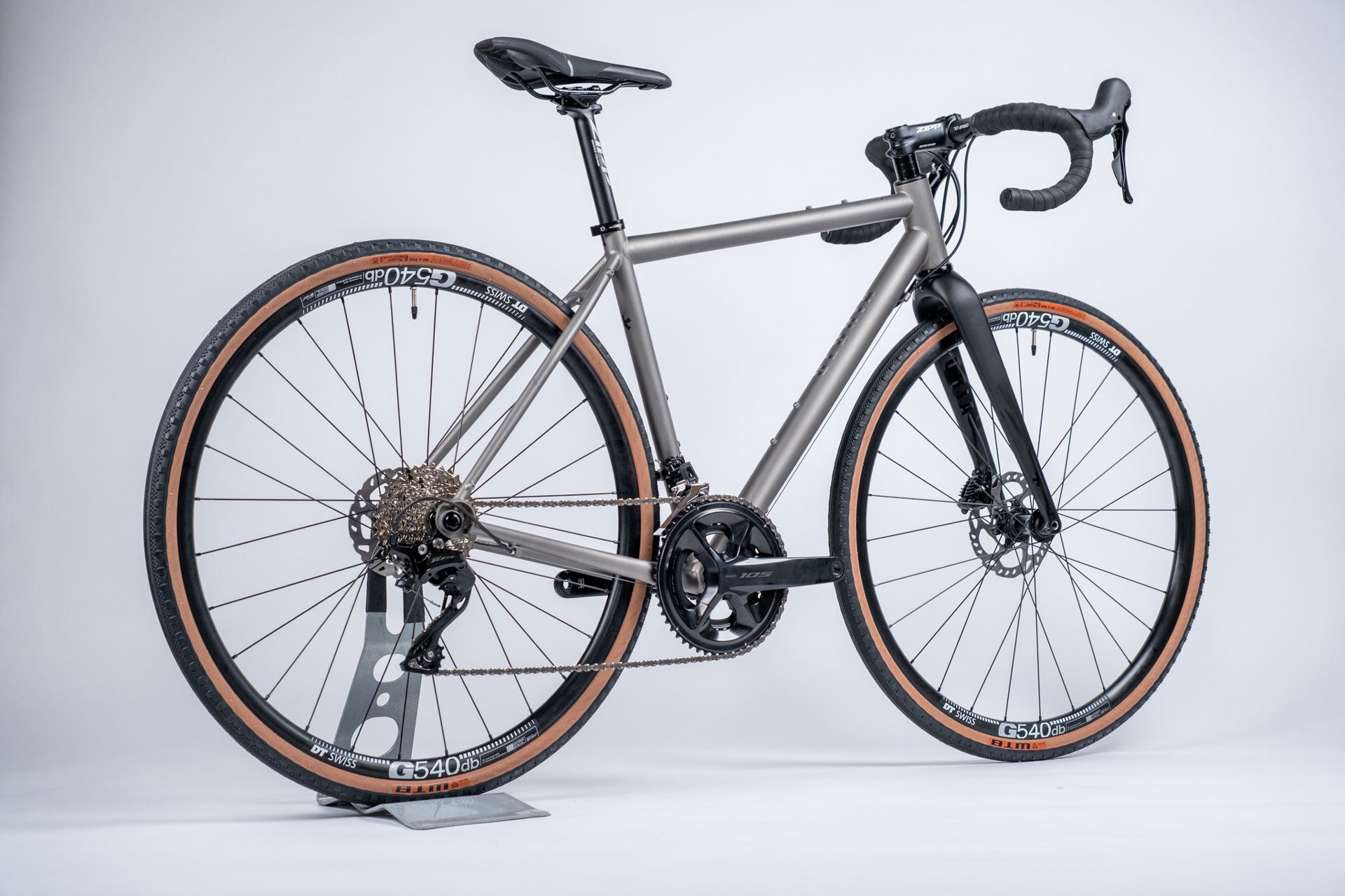 Silver bicycle with black components on a white background