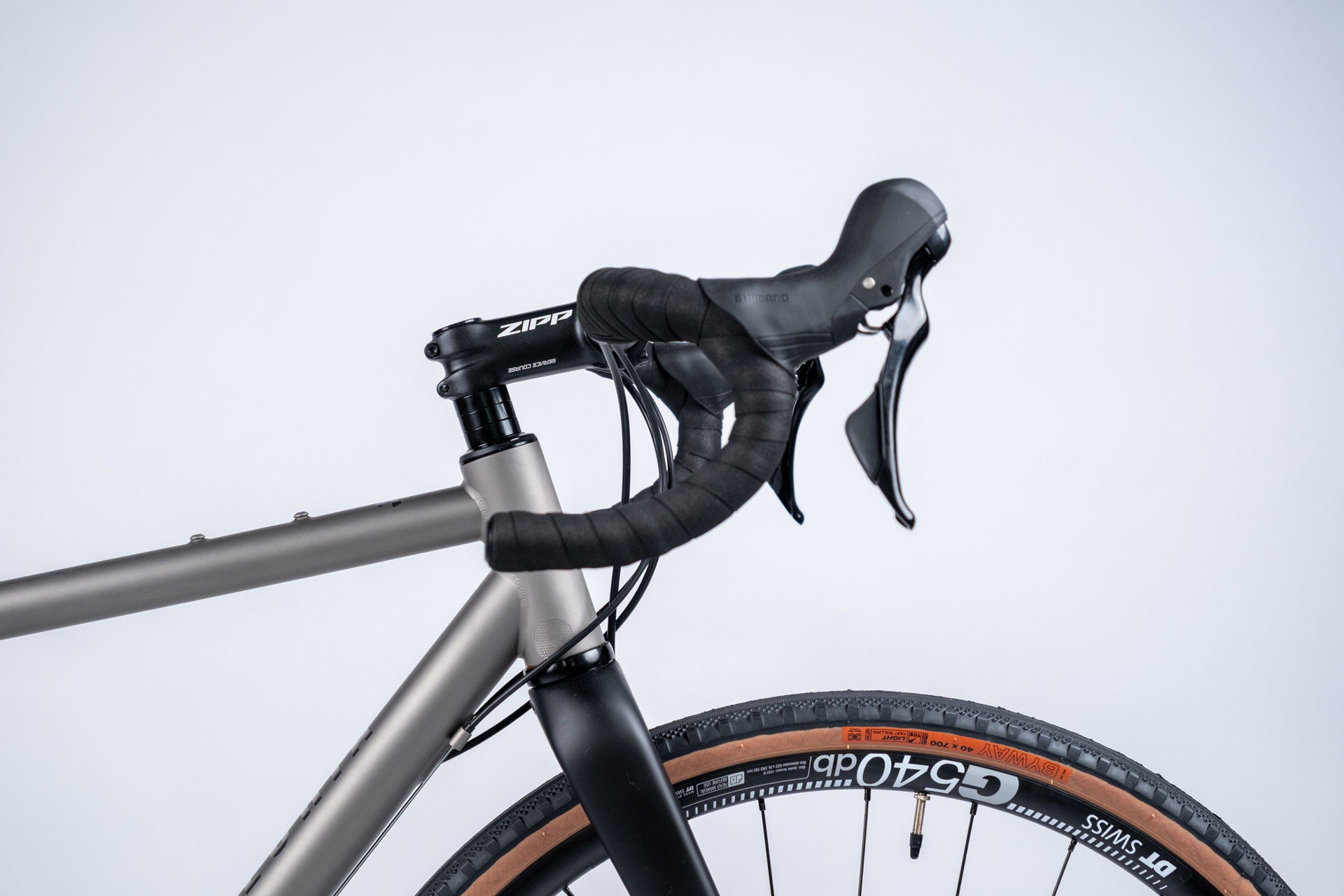 Close-up of a bicycle handlebar with Zipp branding on a light gray background