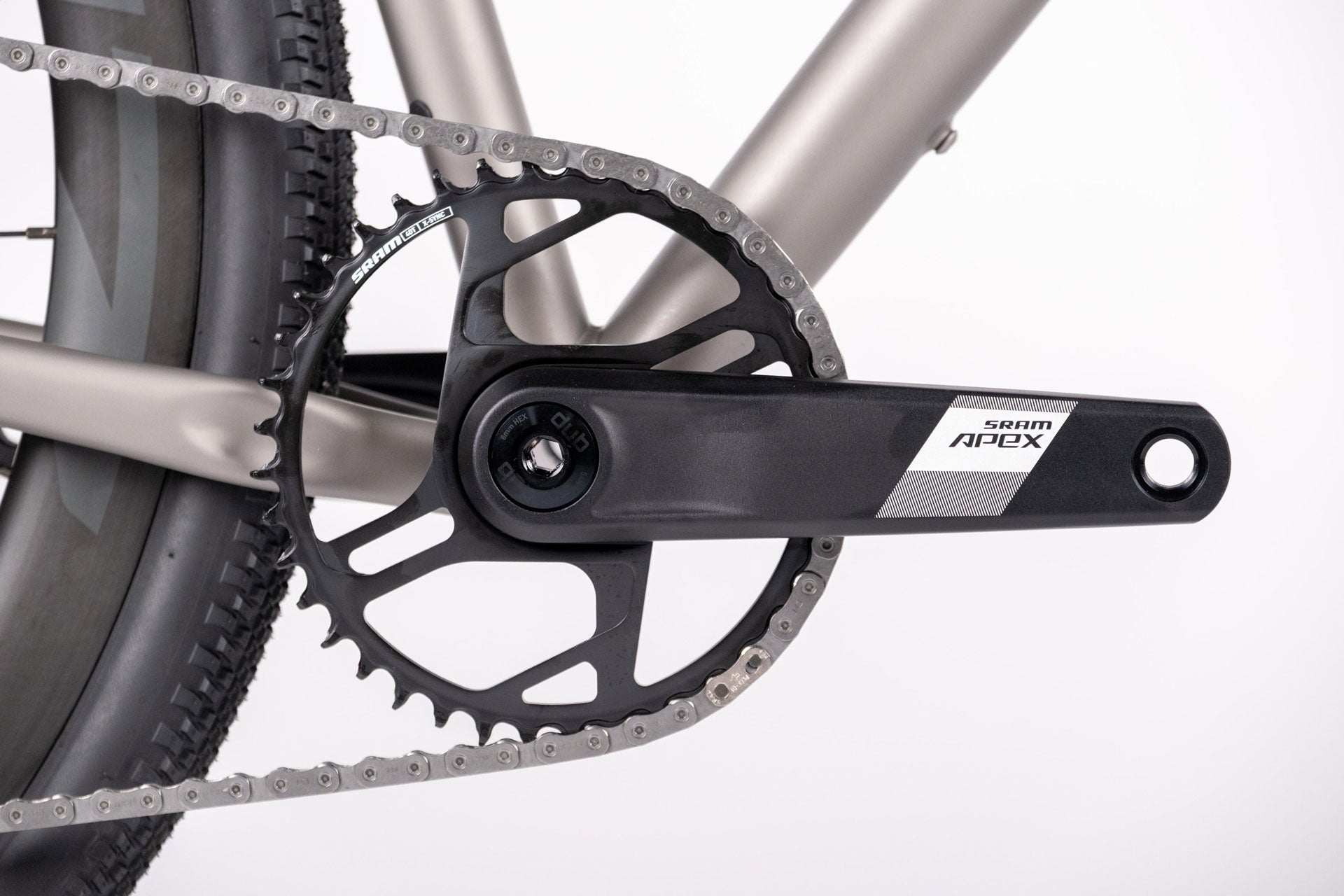Close-up of bicycle crankset and chain on a white background