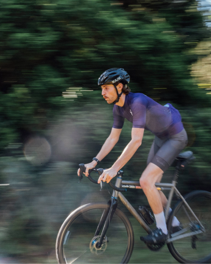 Man cycling outdoors with a blurred background