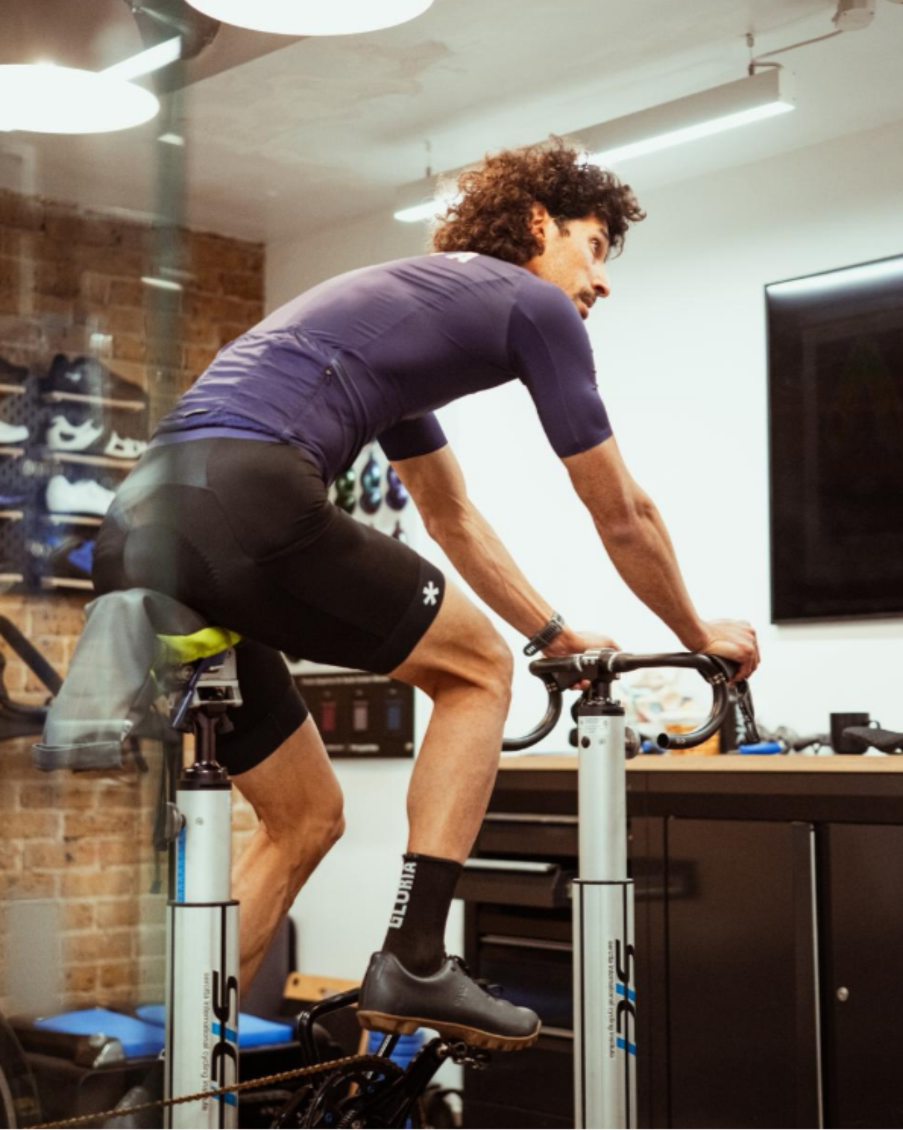 Man using a stationary bike in a gym setting