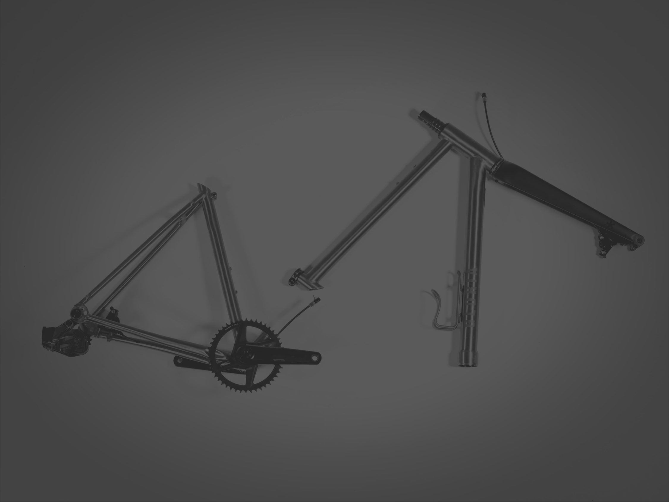 Bicycle titanium frame with components on a gray background