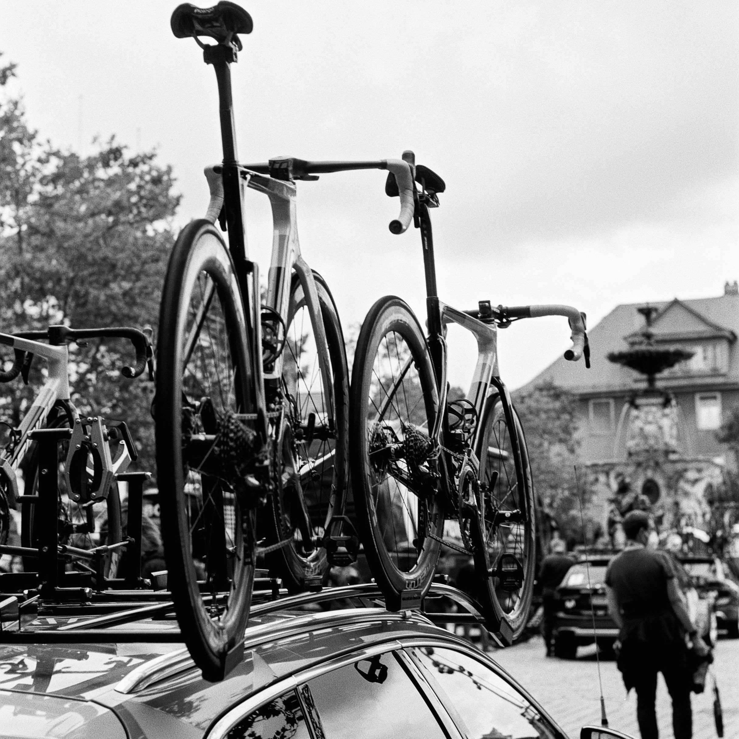 Two carbon bicycles on the roof of a team car
