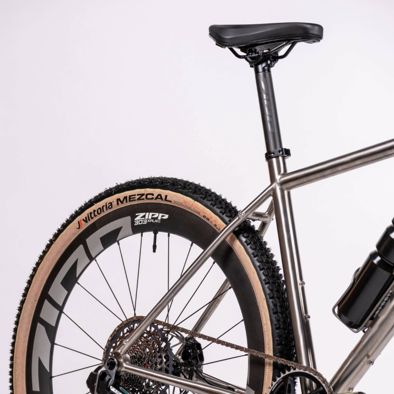 Close-up of a bicycle with Zipp and Vittoria Mezcal branding on a white background