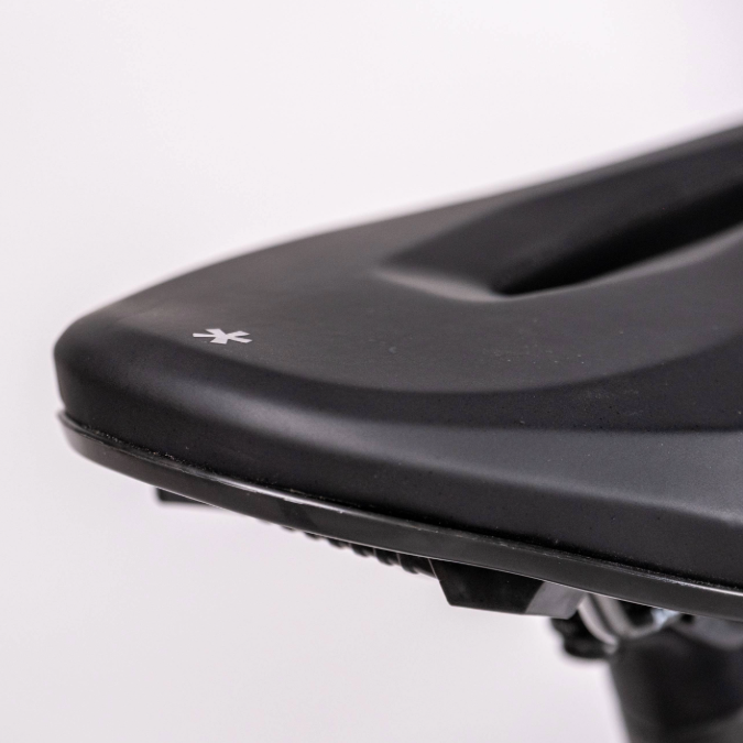 Close-up of a black bicycle seat with a Bluetooth symbol on a light gray background